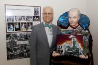 David Forrest, MD, poses next to a figure of himself at the 10th annual CUIMC Fine Arts Exhibition.